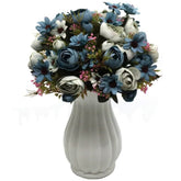 Light blue artificial flower bouquet of peony flowers and greenery in white vase
